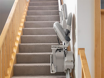Bruno Elite Stairlift with folded seat, armrests and footrest